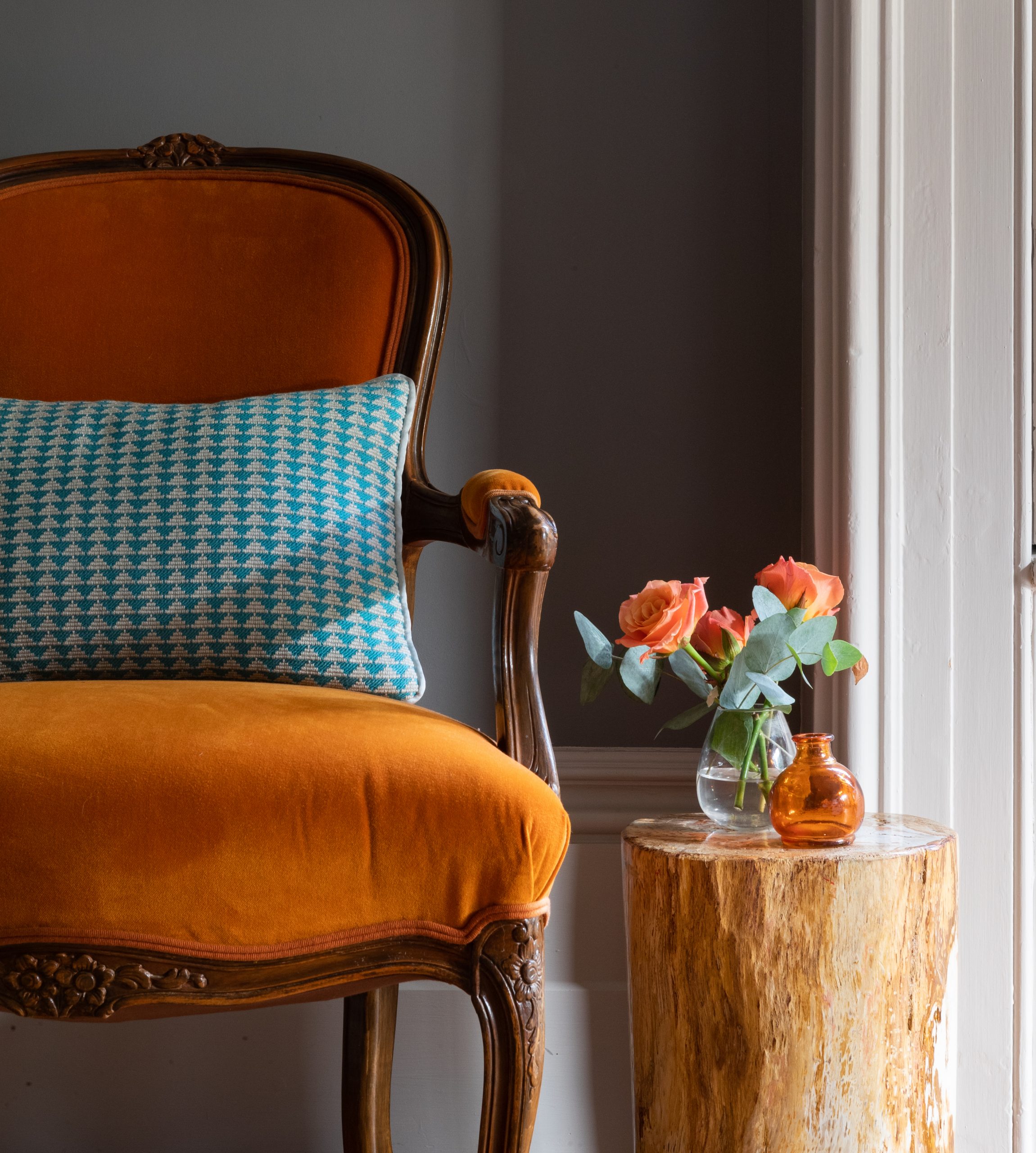orange chair turquoise cushion